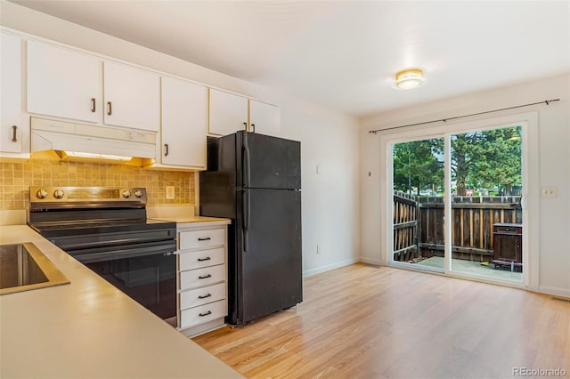 5711 W 92nd Ave Unit 47, Westminster, CO 80031 - kitchen with freestanding refrigerator, stainless steel range with electric cooktop, under cabinet range hood, light countertops, and decorative backsplash