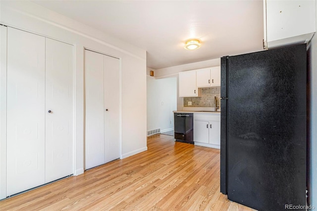5711 W 92nd Ave Unit 47, Westminster, CO 80031 - kitchen featuring black appliances, light wood-style floors, white cabinets, backsplash, and light countertops