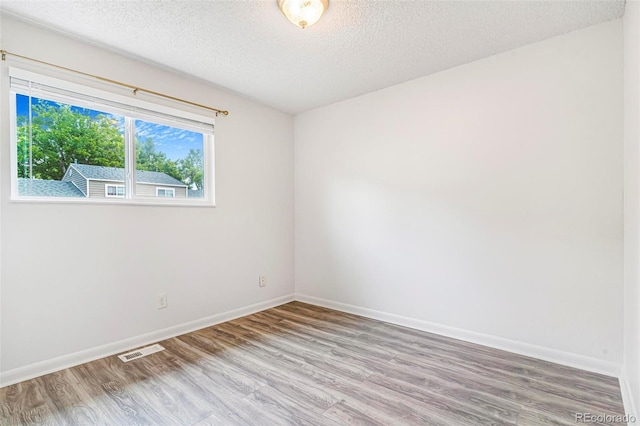 5711 W 92nd Ave Unit 47, Westminster, CO 80031 - empty room featuring wood finished floors, a textured ceiling, and baseboards