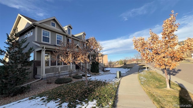 view of snow covered exterior with covered porch