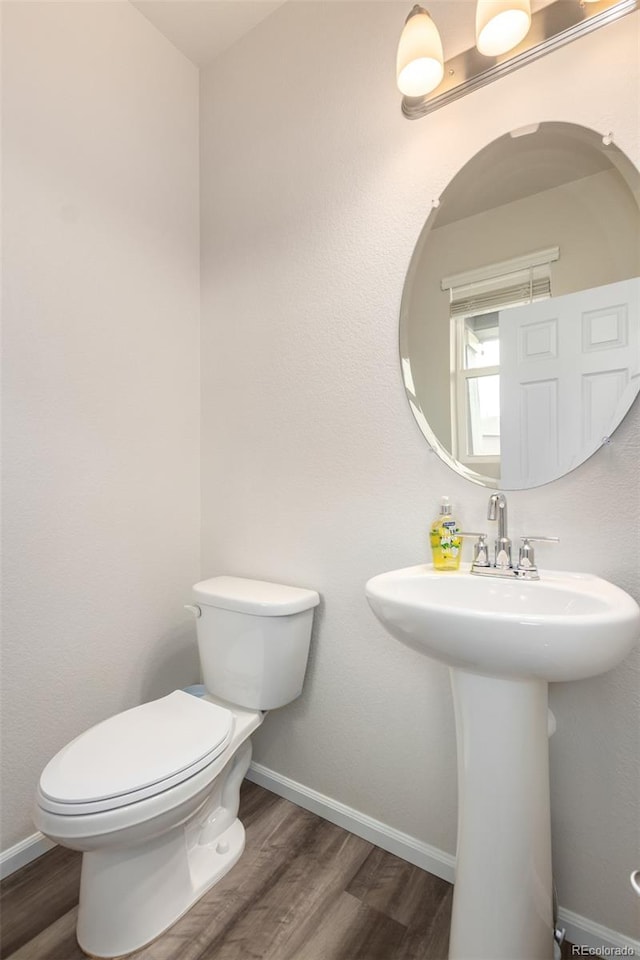 bathroom with sink, hardwood / wood-style floors, and toilet