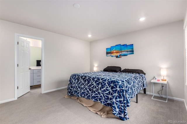 carpeted bedroom with ensuite bath