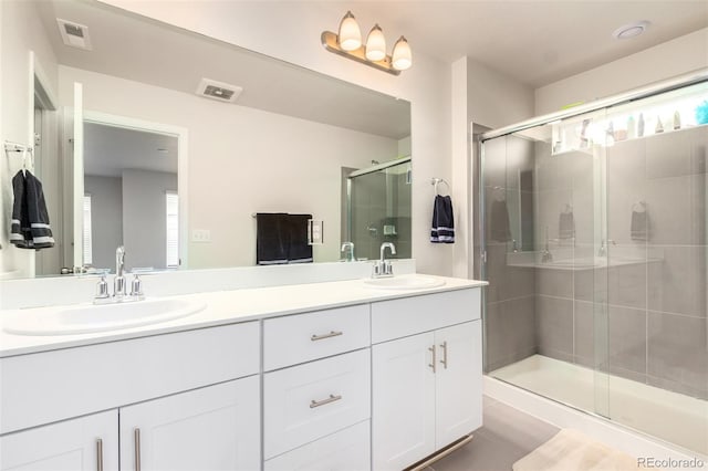 bathroom featuring vanity and a shower with shower door