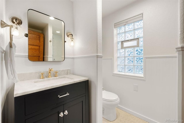 bathroom featuring tile patterned floors, toilet, and vanity