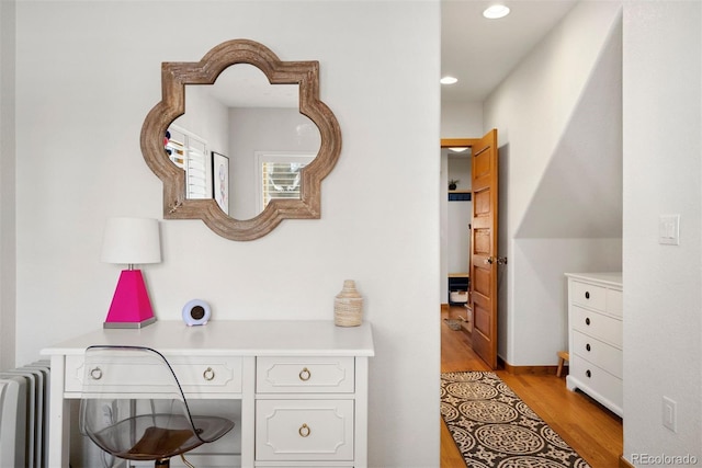 office area with built in desk and light hardwood / wood-style floors