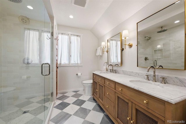 bathroom featuring toilet, walk in shower, vanity, and vaulted ceiling