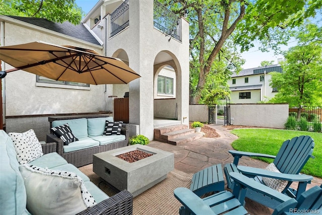 view of patio / terrace with an outdoor living space with a fire pit