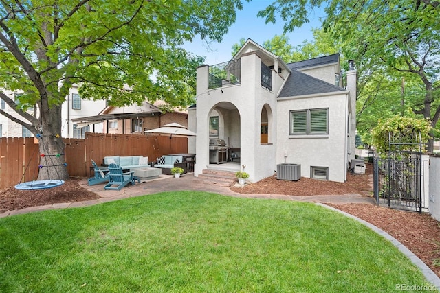 back of property with central air condition unit, a yard, an outdoor hangout area, and a patio