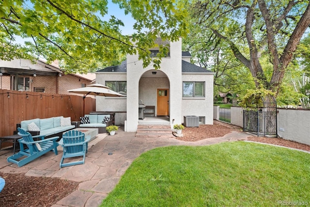 view of front of home featuring a patio area, a front lawn, an outdoor hangout area, and cooling unit