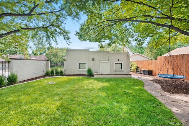 rear view of house featuring a lawn