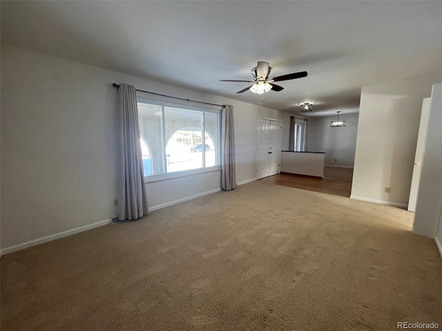 carpeted spare room with ceiling fan