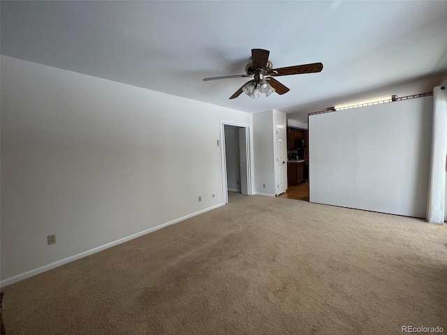 spare room with light colored carpet and ceiling fan