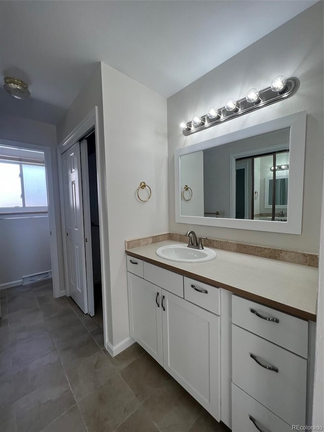 bathroom with tile flooring and vanity