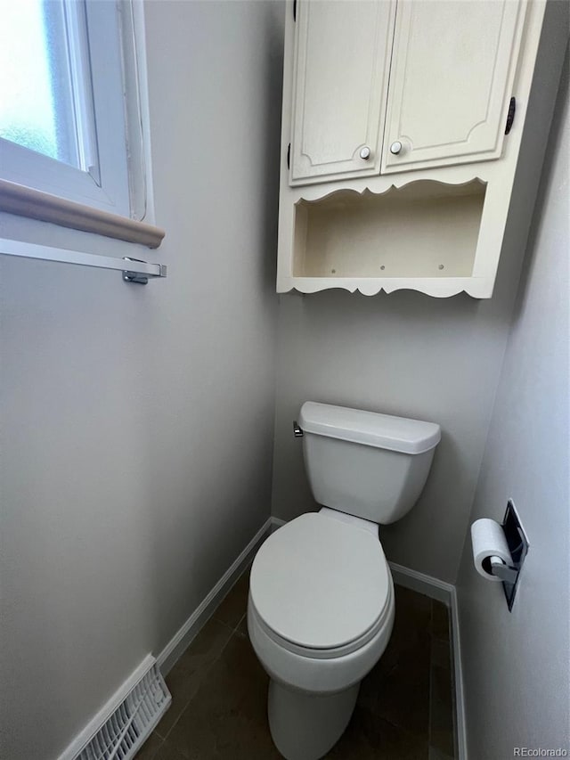 bathroom featuring tile floors and toilet