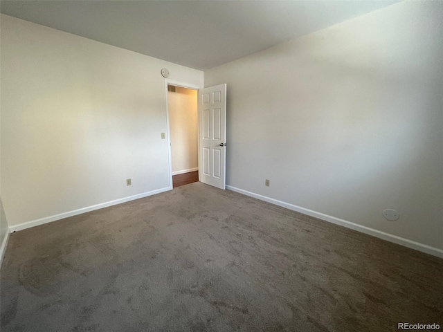 empty room with dark carpet