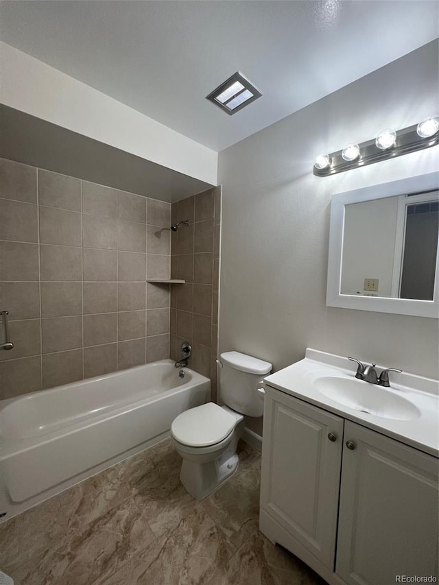 full bathroom with tile flooring, vanity, tiled shower / bath combo, and toilet