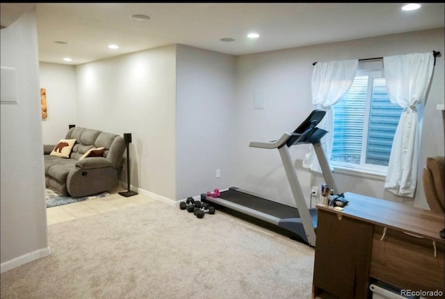 exercise room featuring light carpet