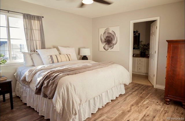 bedroom with ceiling fan, connected bathroom, and hardwood / wood-style flooring