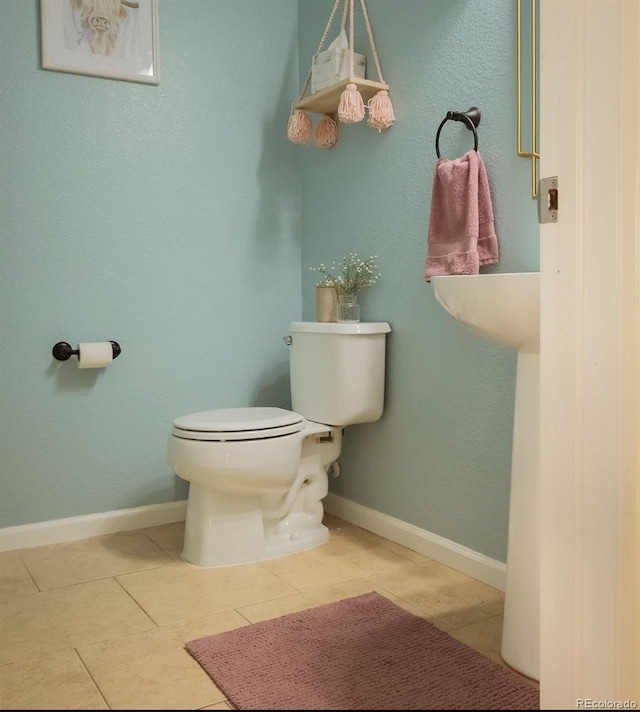 bathroom with toilet and tile patterned floors