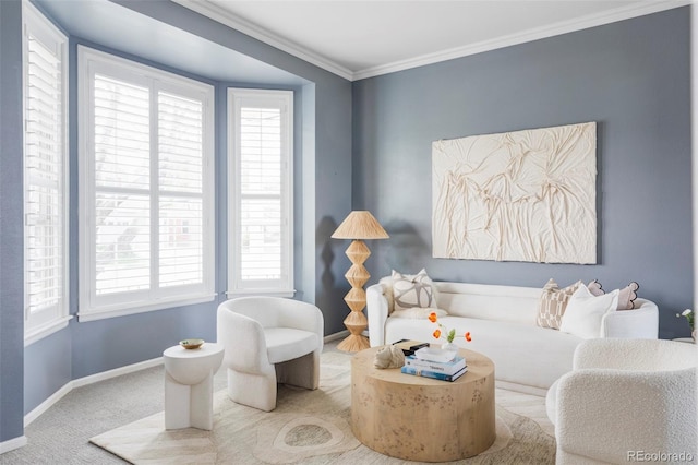 sitting room with plenty of natural light, baseboards, carpet flooring, and crown molding
