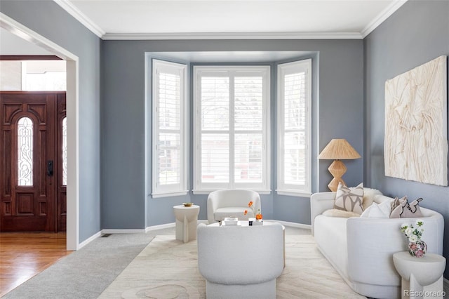 entryway featuring ornamental molding, plenty of natural light, carpet floors, and baseboards
