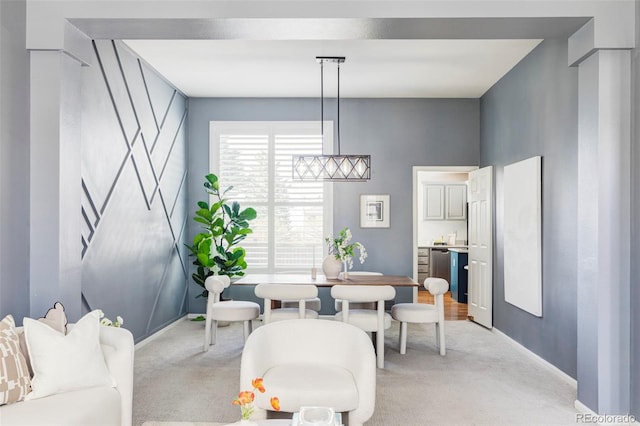 dining room with light carpet and baseboards