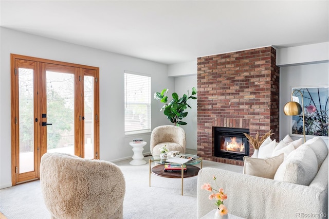 carpeted living area with a brick fireplace and baseboards