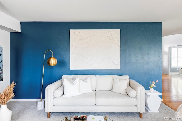 living room with baseboards and wood finished floors