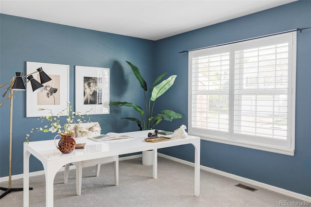 carpeted office with healthy amount of natural light and baseboards