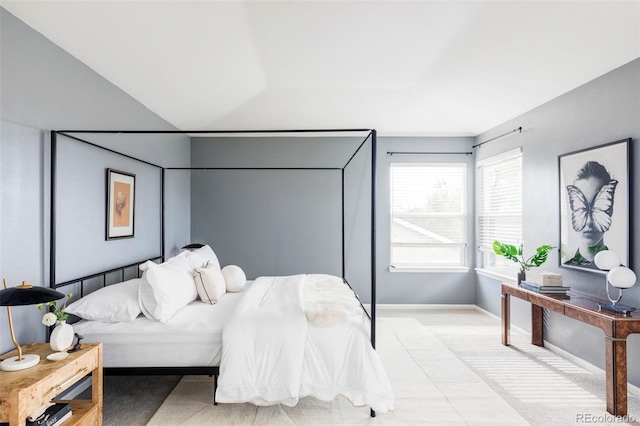 bedroom with light carpet and baseboards