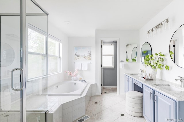 full bath with a bath, tile patterned flooring, double vanity, a stall shower, and baseboards