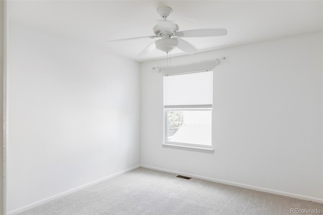 empty room with carpet floors, baseboards, and a ceiling fan