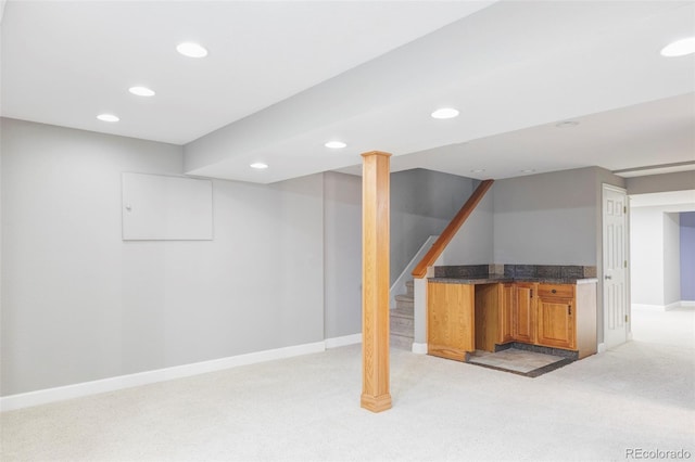 finished basement featuring recessed lighting, light colored carpet, baseboards, and stairs
