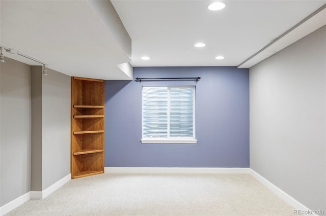 empty room featuring carpet floors, recessed lighting, and baseboards