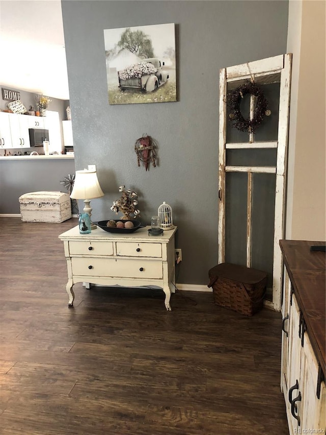 interior space featuring baseboards and wood finished floors