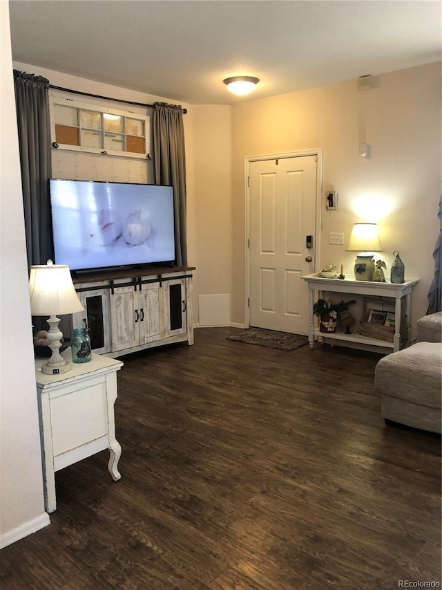 living room with wood finished floors and baseboards