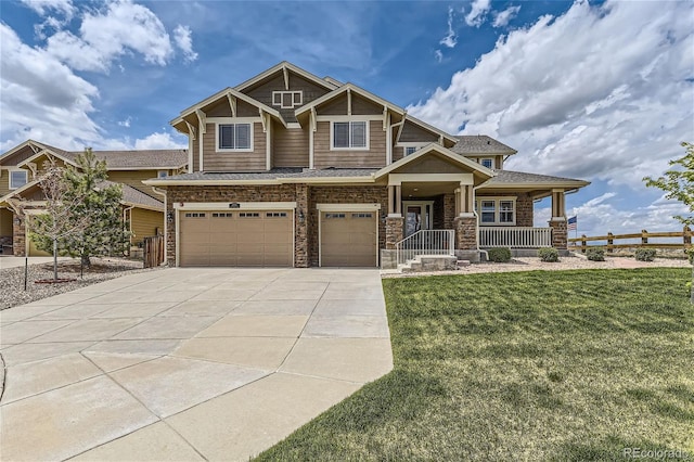 craftsman house featuring covered porch, a front yard, and a garage