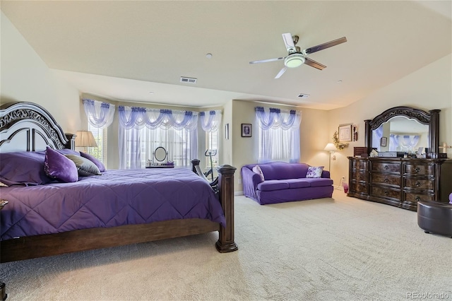 carpeted bedroom with ceiling fan and multiple windows