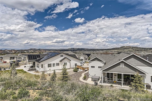 back of property with a patio and a mountain view