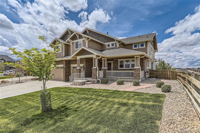 craftsman inspired home featuring a garage, a front yard, and covered porch