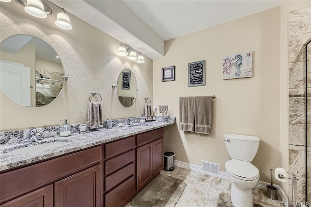 bathroom with walk in shower, vanity, and toilet