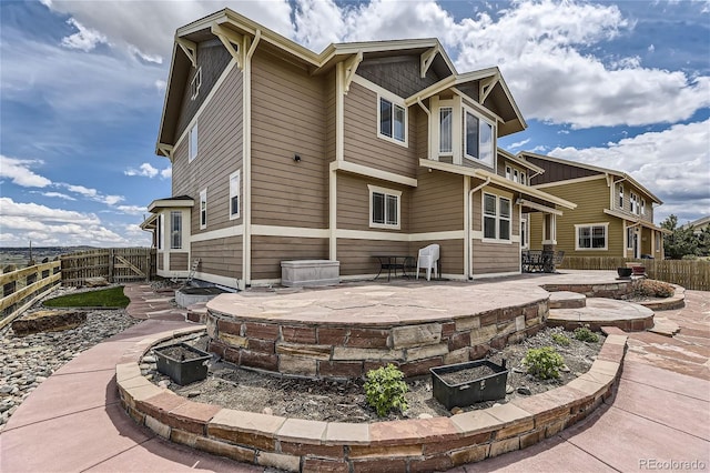 back of house with a patio and a fire pit