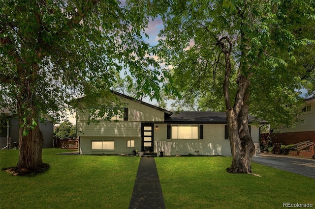 3545 Moorhead Ave, Boulder, CO 80305 - tri-level home featuring a front yard, brick siding, and asphalt driveway