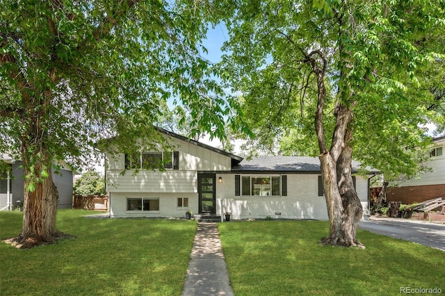 3545 Moorhead Ave, Boulder, CO 80305 - tri-level home featuring a front yard, a garage, brick siding, and driveway