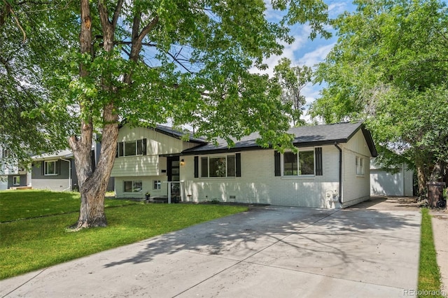 3545 Moorhead Ave, Boulder, CO 80305 - tri-level home with driveway, a front yard, and brick siding