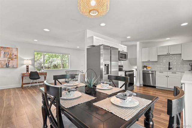 3545 Moorhead Ave, Boulder, CO 80305 - dining area featuring light wood-type flooring, recessed lighting, baseboards, and bar area