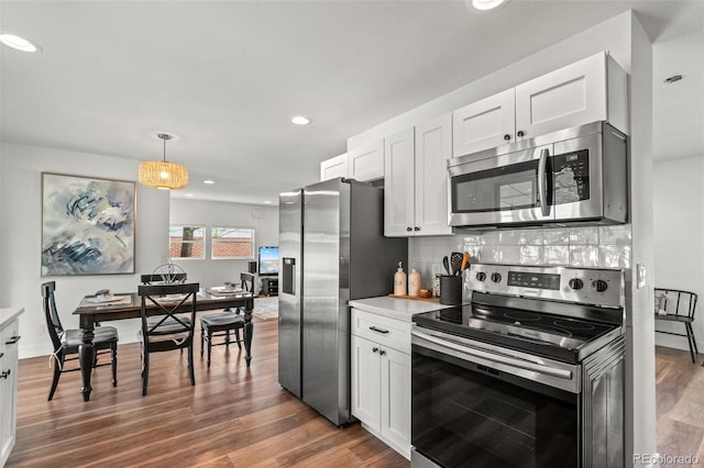 3545 Moorhead Ave, Boulder, CO 80305 - kitchen featuring stainless steel appliances, dark wood finished floors, white cabinetry, recessed lighting, and light countertops