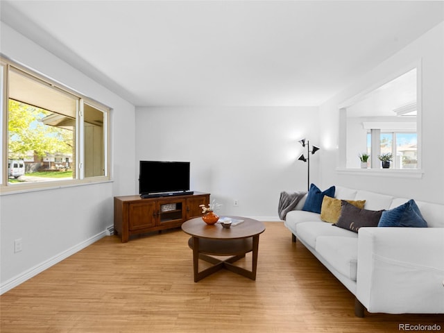 4779 S Owens Way, Littleton, CO 80127 - living room with healthy amount of natural light, light wood-style flooring, and baseboards