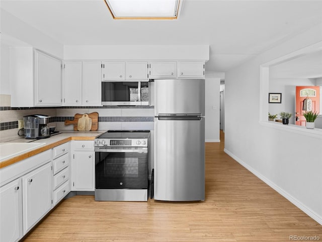 4779 S Owens Way, Littleton, CO 80127 - kitchen featuring stainless steel appliances, white cabinets, tasteful backsplash, and baseboards