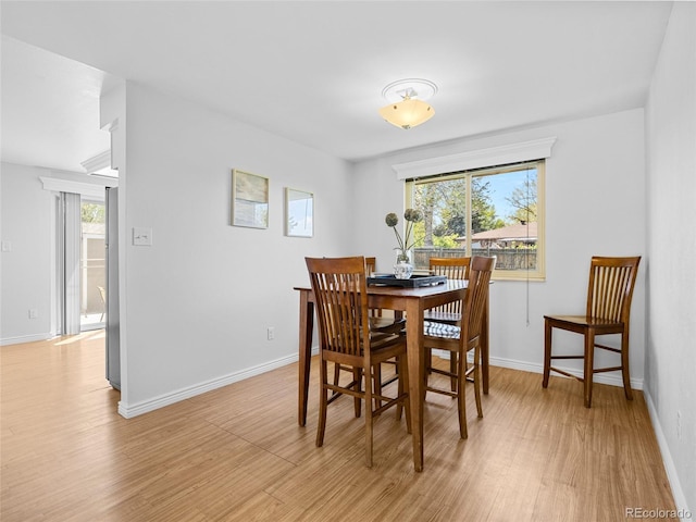 4779 S Owens Way, Littleton, CO 80127 - dining space featuring light wood-type flooring, healthy amount of natural light, and baseboards